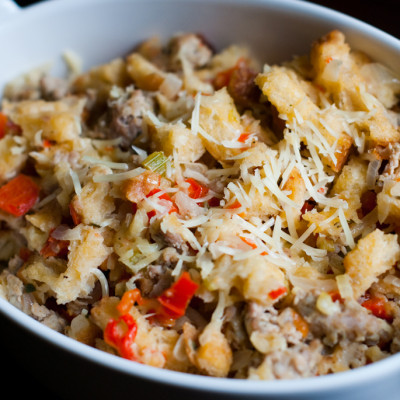 italian-stuffing-with-sausage-and-parmesan-cheese-plated-in-buttered-casserole-dish