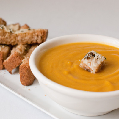 a-bowl-of-warm-cumin-squash-soup-with-a-cheesy-sage-crouton