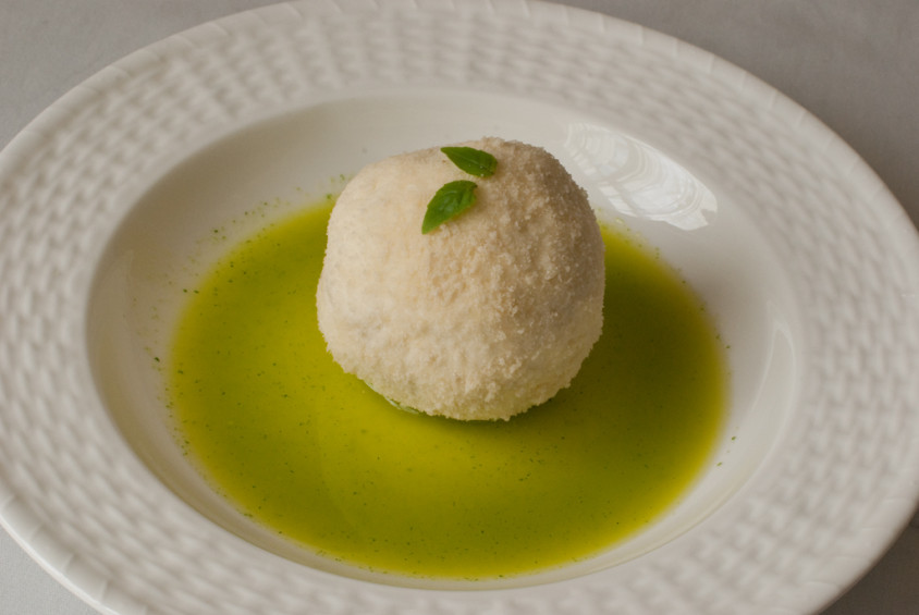 parmesan-and-panko-encrusted-goat-cheese-in-basil-olive-oil-and-basil-leaves-on-top