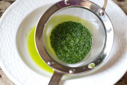 using-a-sieve-to-remove-the-basil-leaves-in-the-oil