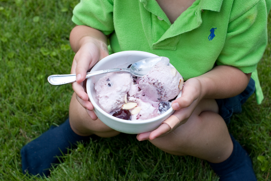 enjoying-cherry-ice-cream-in-the-grass